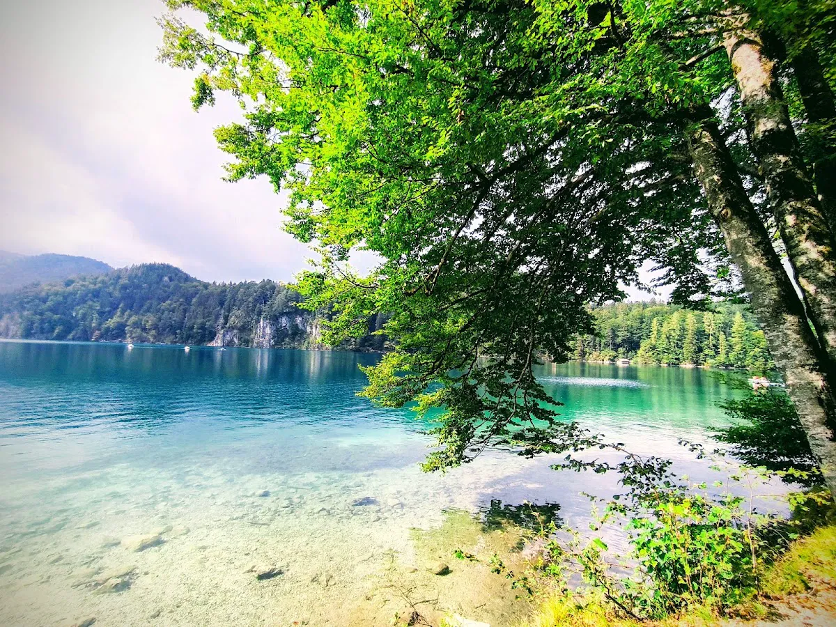 Pindarplatz viewpoint with Hohenschwangau Castle reflection in turquoise water