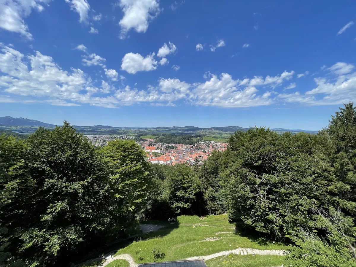 October mist in valley with Neuschwanstein emerging above fog layer