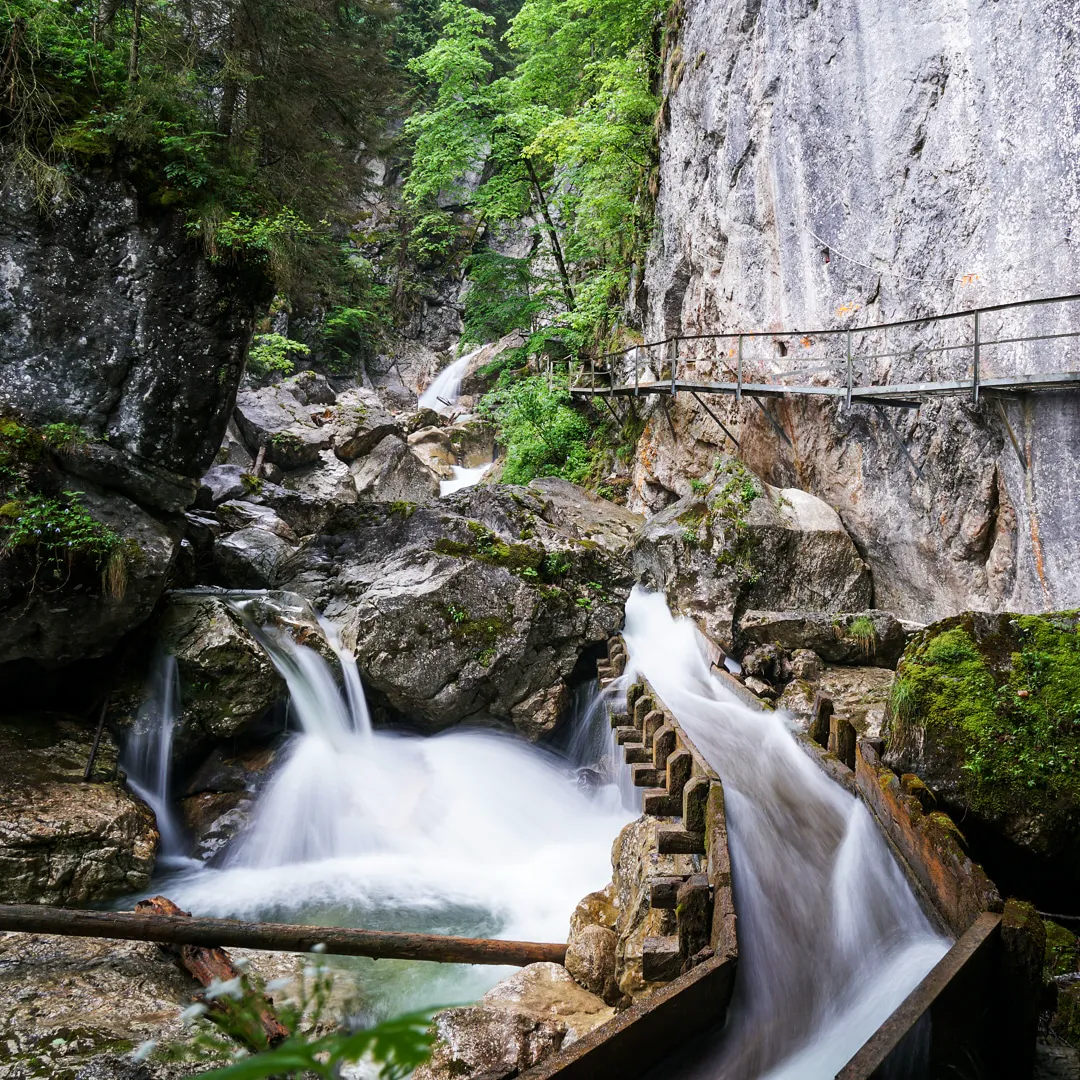 View from Marienbrücke looking down into Pöllat Gorge with waterfall visible