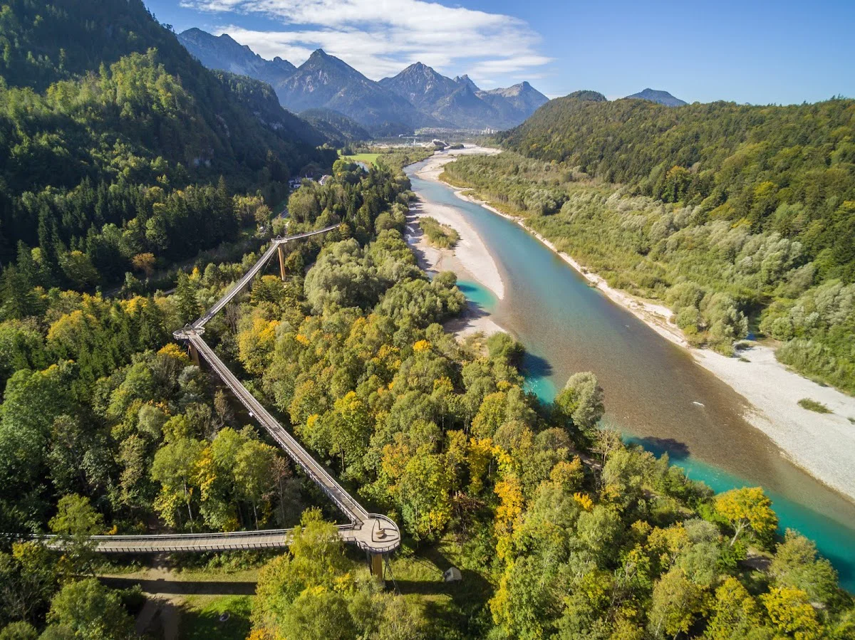 Aerial view of the tr eetop walkway crossing the turquoise Lech River