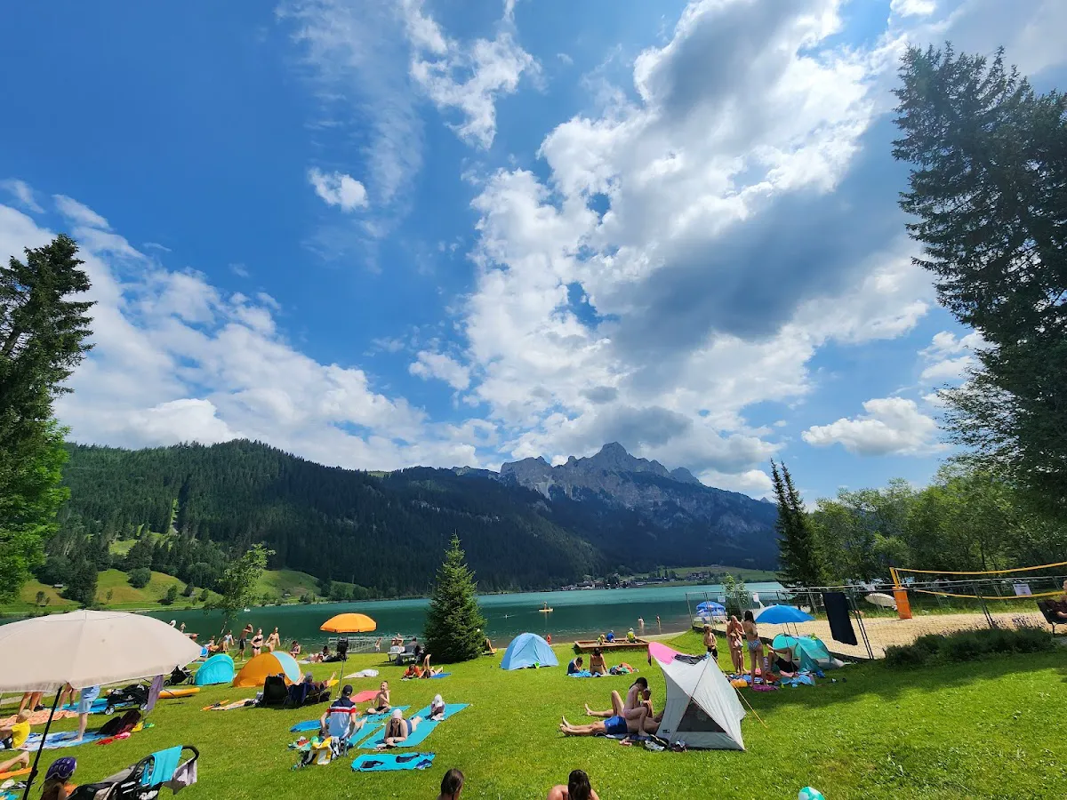 Crystal-clear Haldensee lake with boats and Alpine peaks